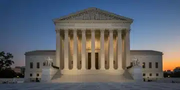 United States Supreme Court building illuminated at dusk, representing legal authority.