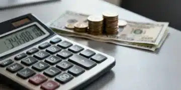 Calculator with coins and dollar bills, representing personal loan interest rate calculations for debt consolidation.